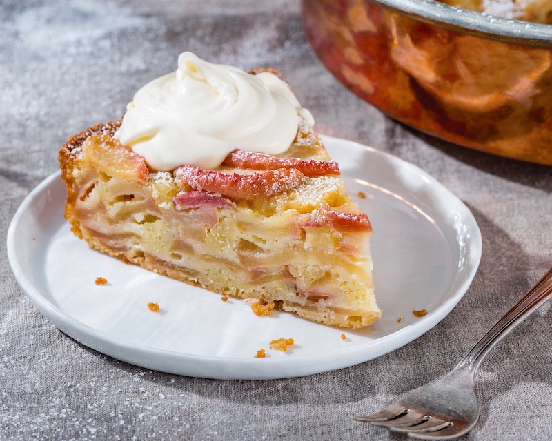 French Apple Cake on white plate on gray surface