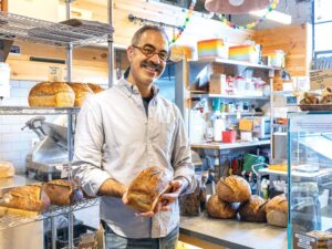 The Rise of Small State Provisions Kevin Masse with a loaf of bread inside of Small State Provisions
