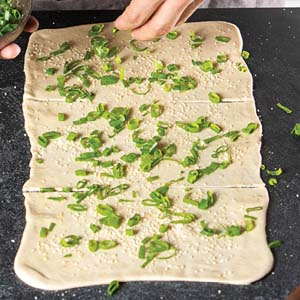 adding scallions to dough