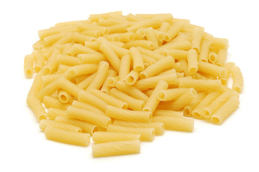 Dried pasta against a white background. The pasta is tube-shaped and straight.