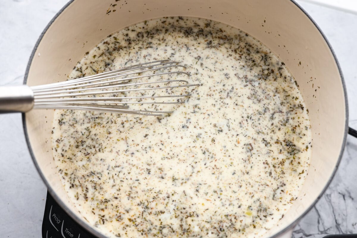 Seasonings, chicken broth, and half and half added to the pot. 