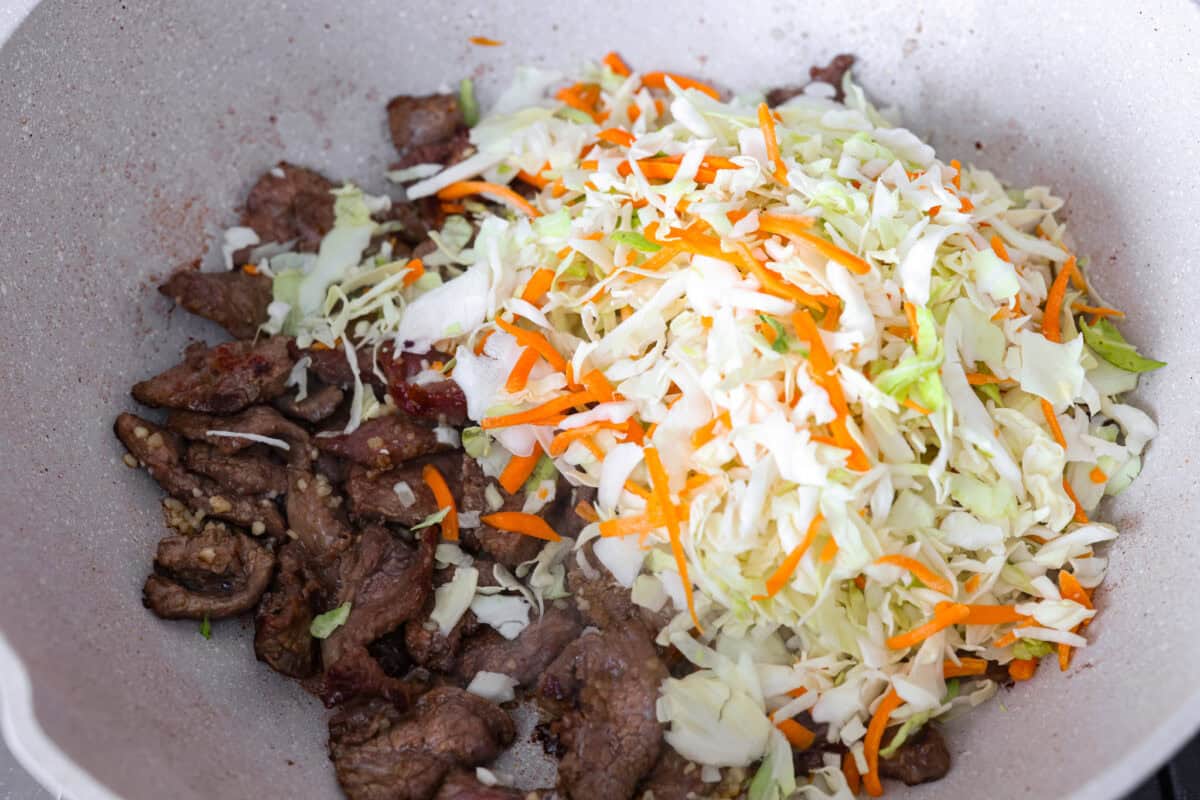 Cooked beef with coleslaw mix.