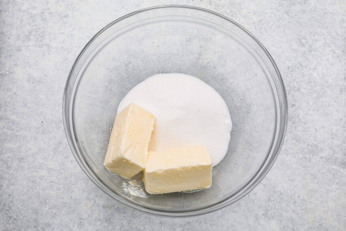 Sugar and butter in a mixing bowl. 
