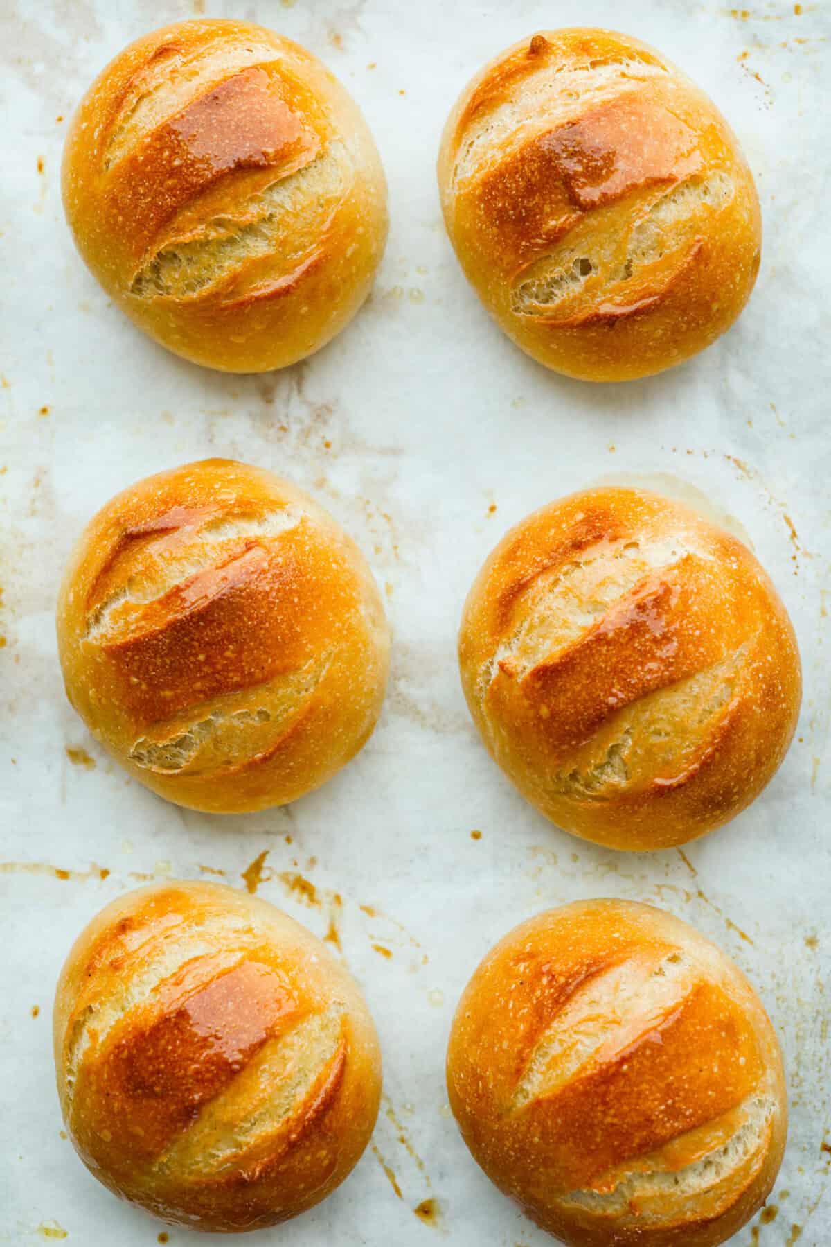 French bread rolls freshly baked and cooling on the counter. 