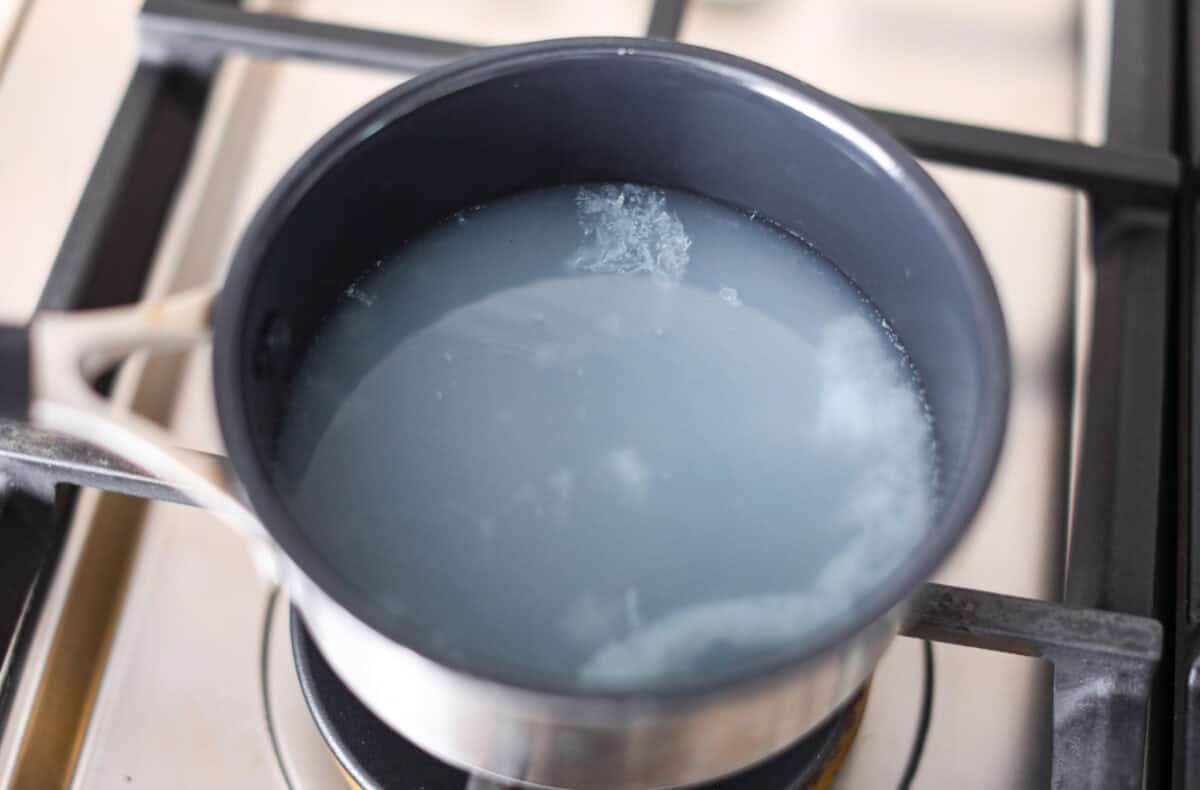 Overhead shot of lemonade in a pot on the stovetop. 