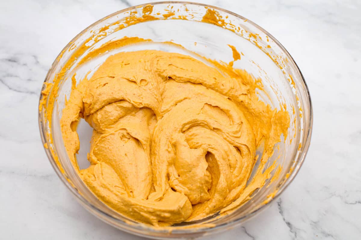 Overhead shot of pumpkin and cream cheese mixture in a glass bowl. 