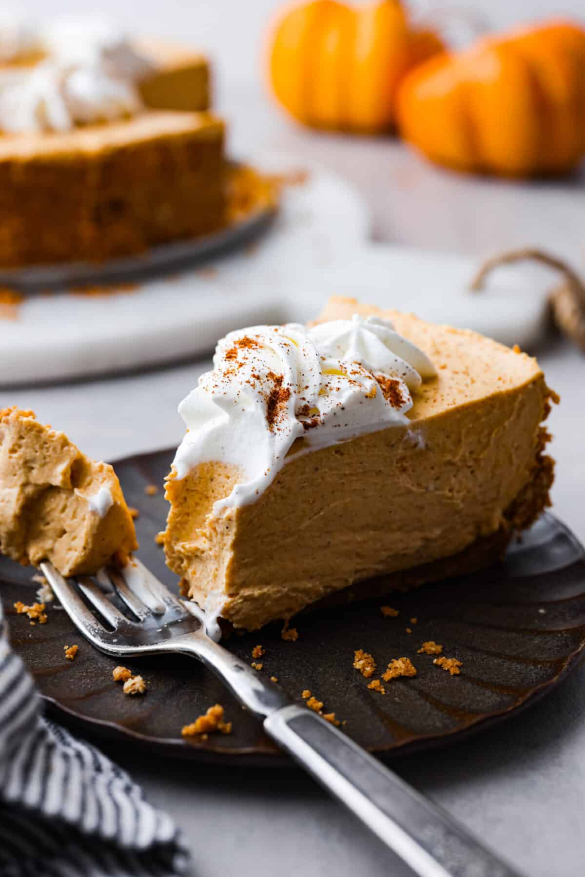 Close up shot of plated slice of no-bake pumpkin cheesecake. 