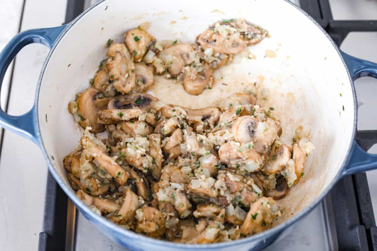 Overhead shot of mushroom mixture with flour in a skillet. 