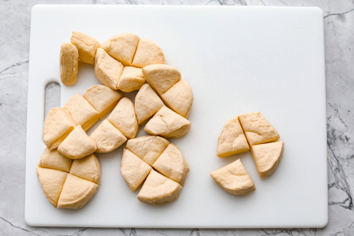 Biscuits cut up on a cutting board. 