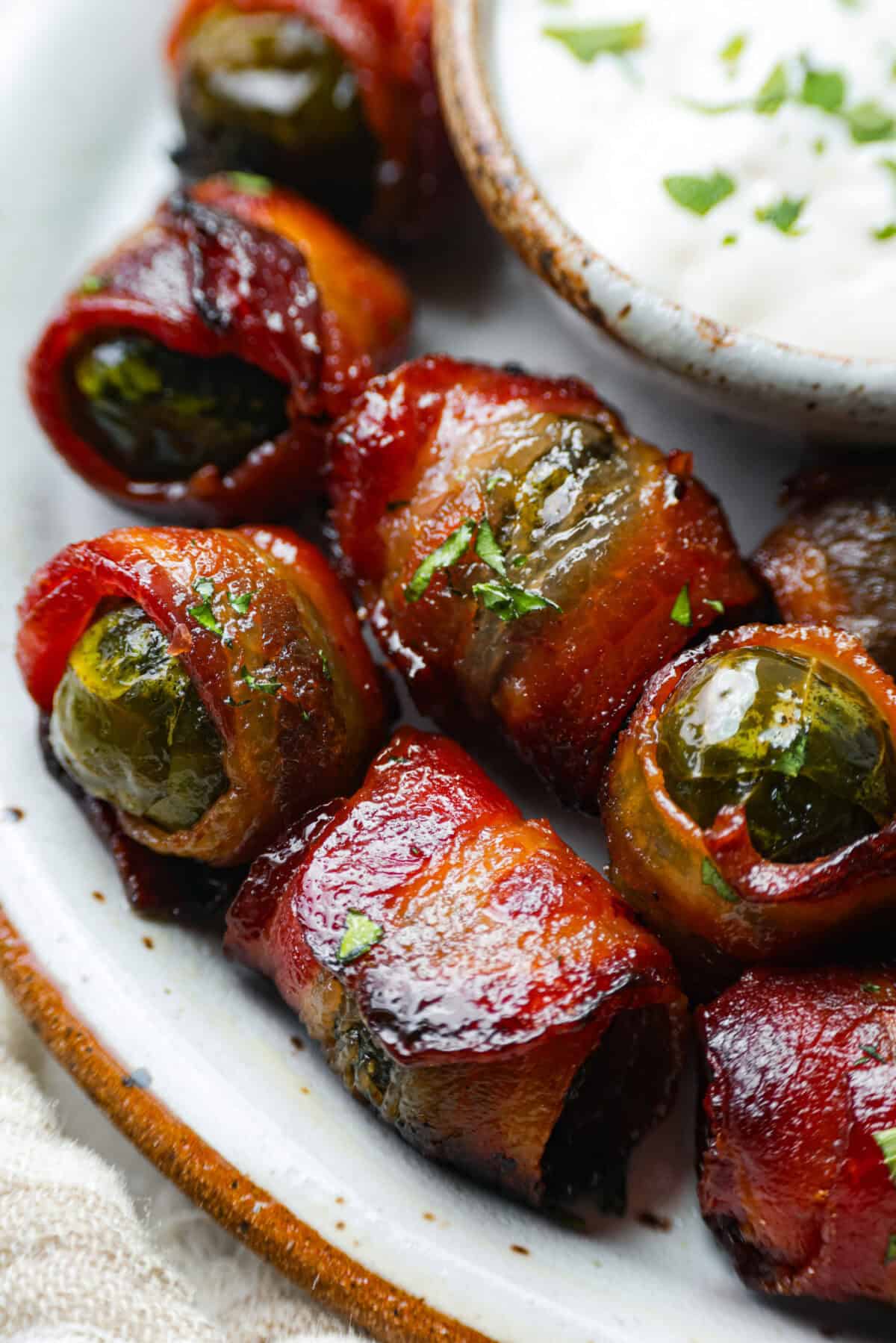 Close up shot of the bacon wrapped Brussels sprouts.