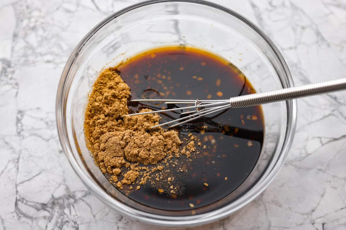 Sauce ingredients being whisked together in a bowl. 