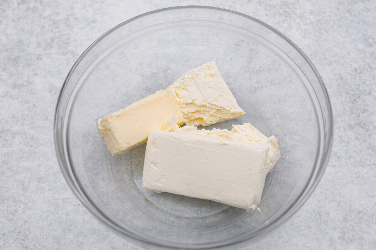 Cream cheese and butter added to a bowl. 