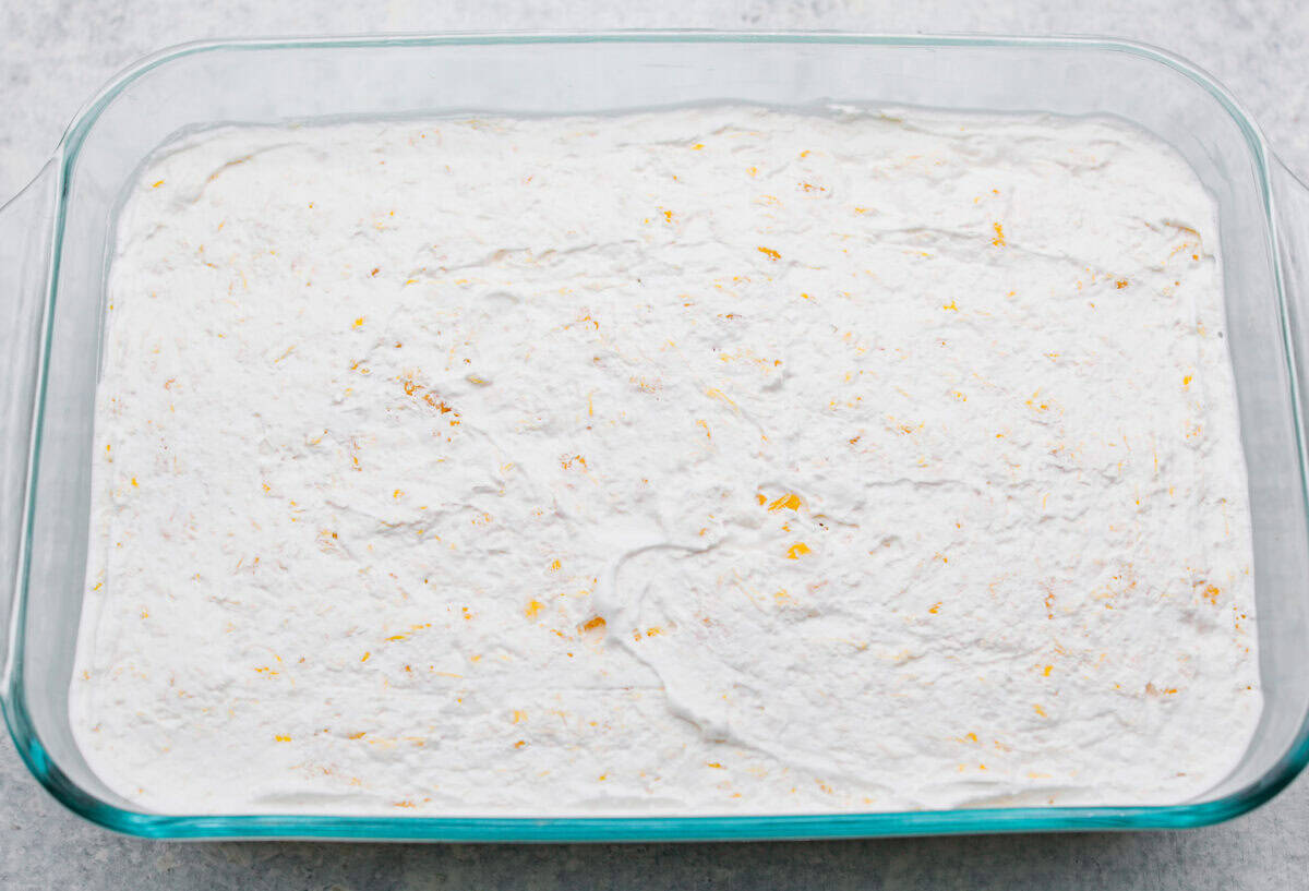 Whipped topping added to the top of the cream cheese mixture, ready to go in the fridge to chill. 