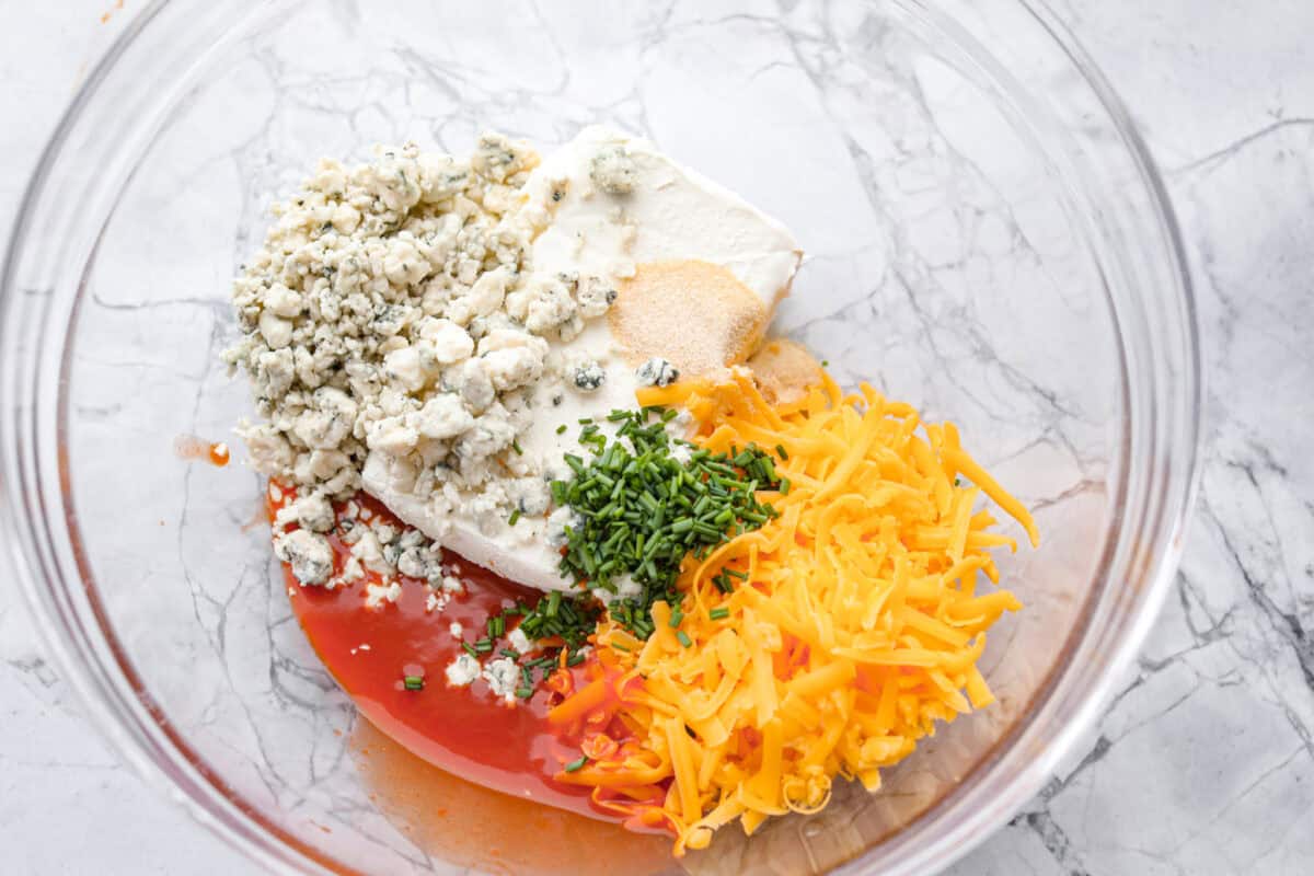 First photo of the buffalo cream cheese ingredients in a glass bowl.