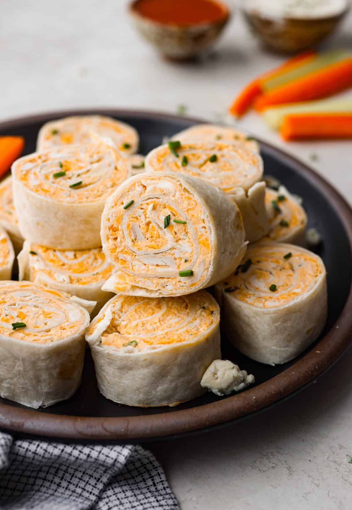 Close view of buffalo chicken pinwheels on a plate.