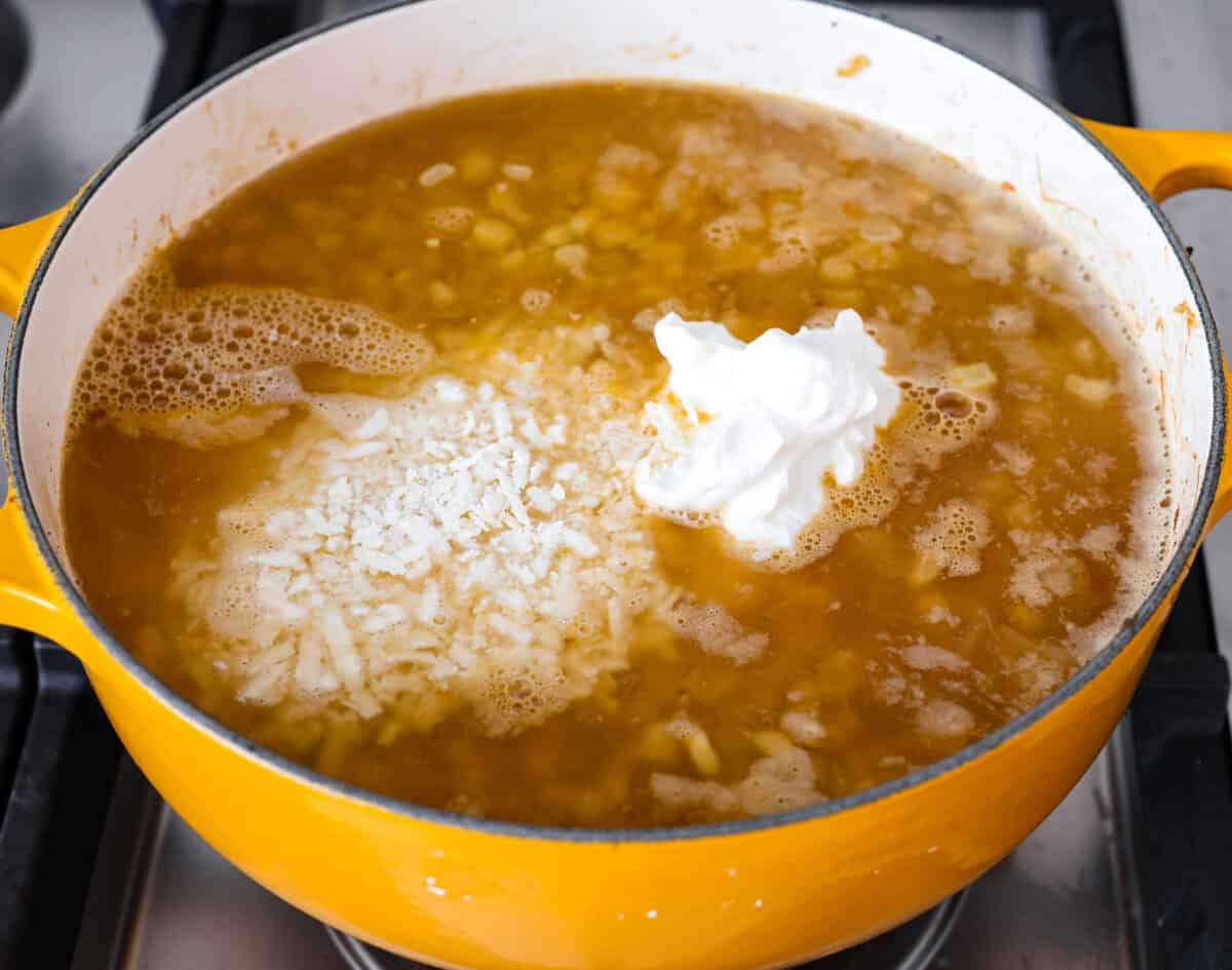 Angle shot of corn and onion mixture with vegetable broth, sour cream and cheese mixed in. 