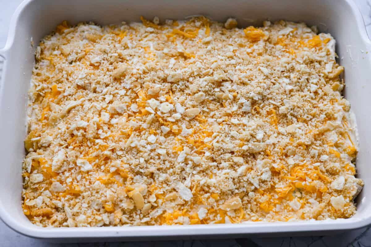 Ritz cracker crumbs spread over the top of the casserole, ready to be baked. 