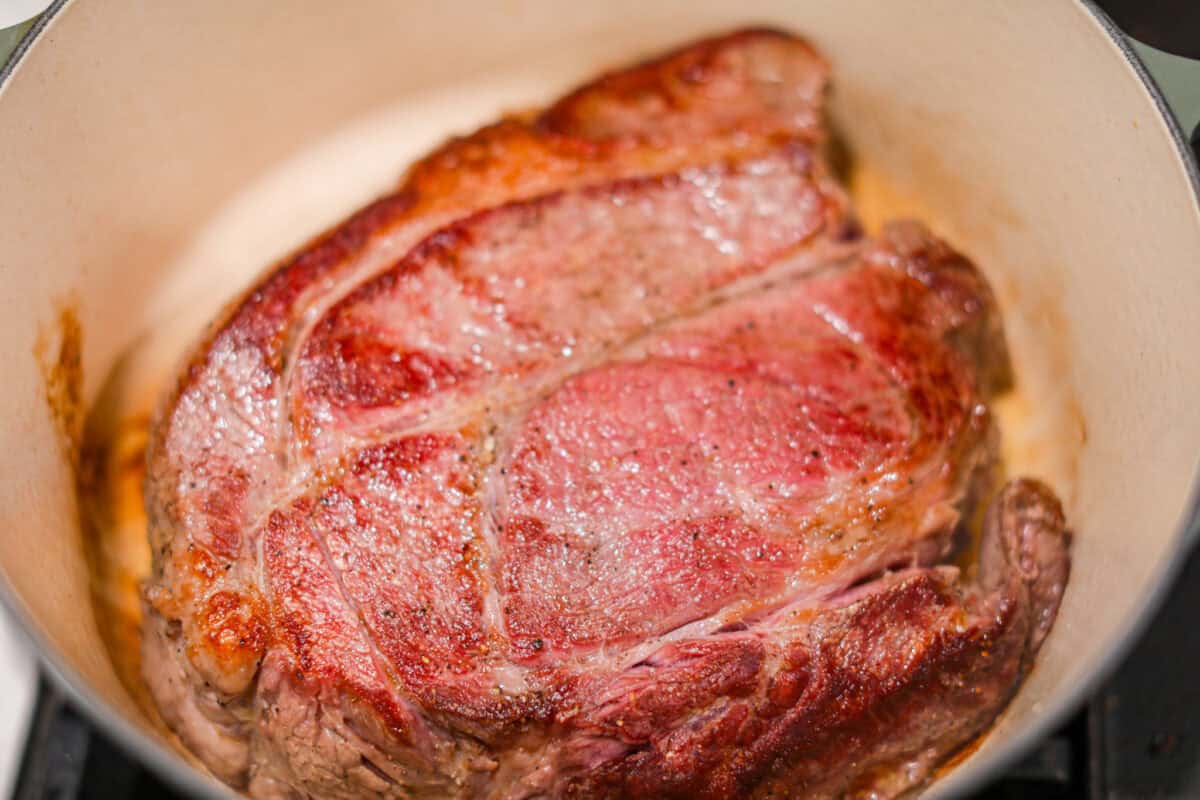 Pot roast browning in a dutch oven.