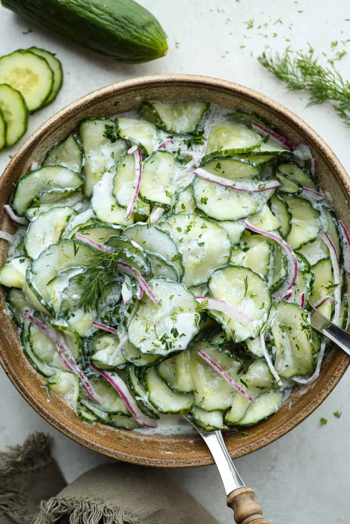 Overhead shot of German cucumber salad in a serving dish. 