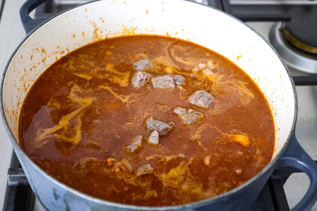 Browned beef chunks added to the broth. 