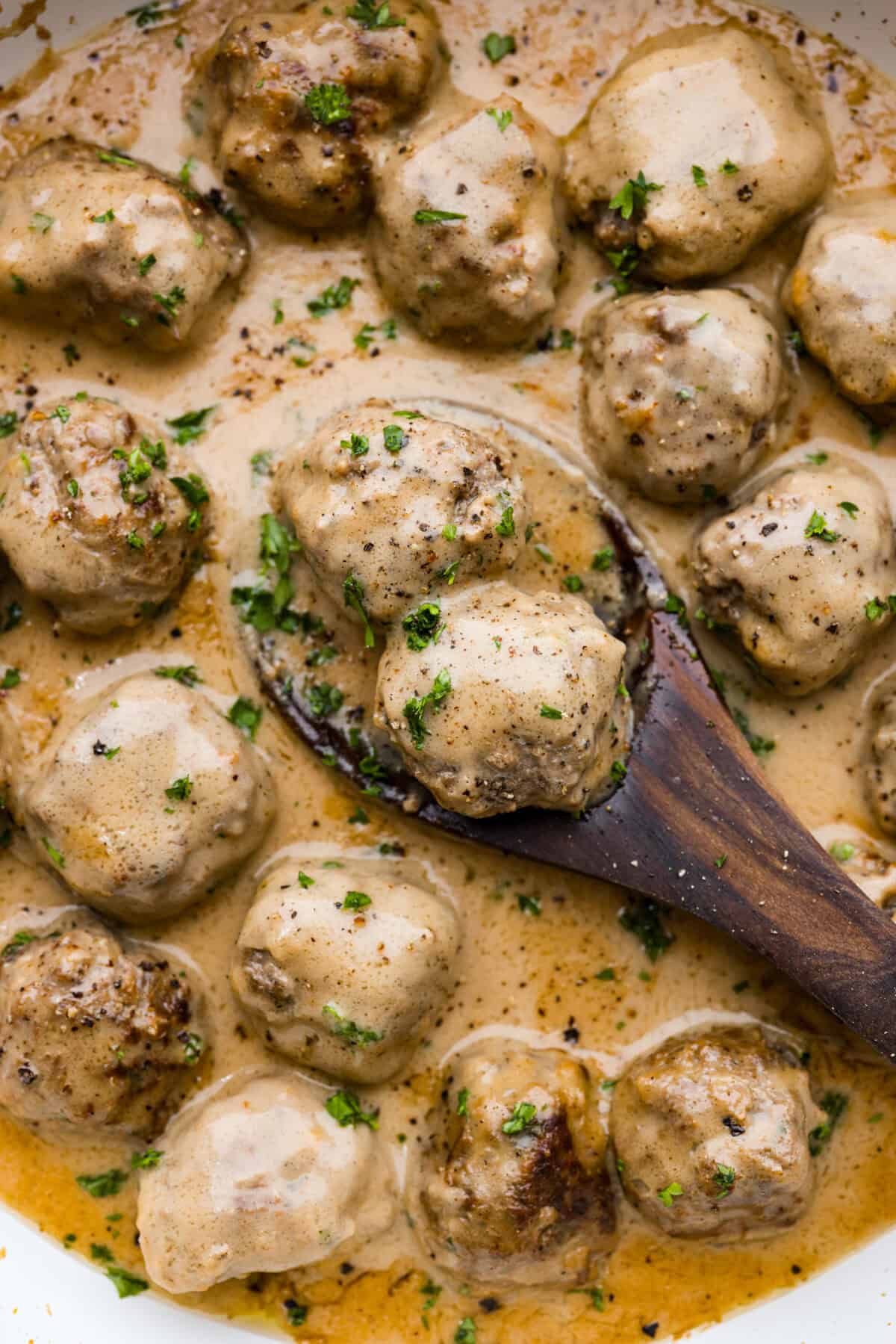 A close up of Swedish meatballs in sauce. 