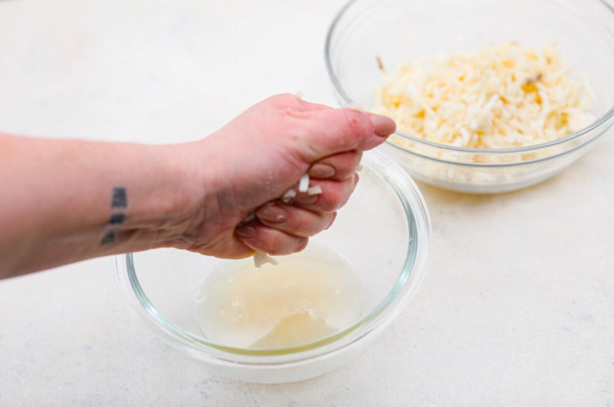 Someone squeezing the water out of the hashbrowns.