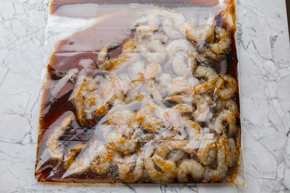 A ziplock bag with marinade and shrimp in side. 