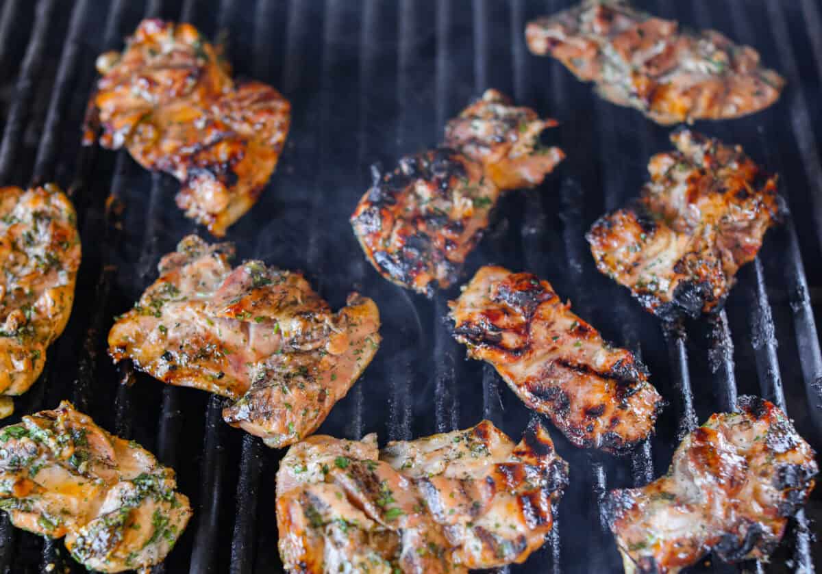 Marinated chicken being cooked on a grill. 