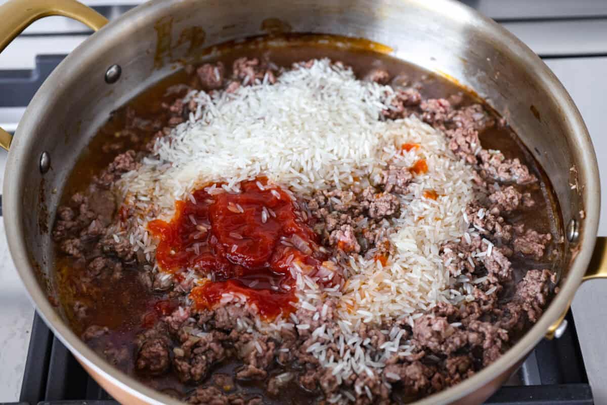 Rice, ketchup and other ingredients added to the ground beef.