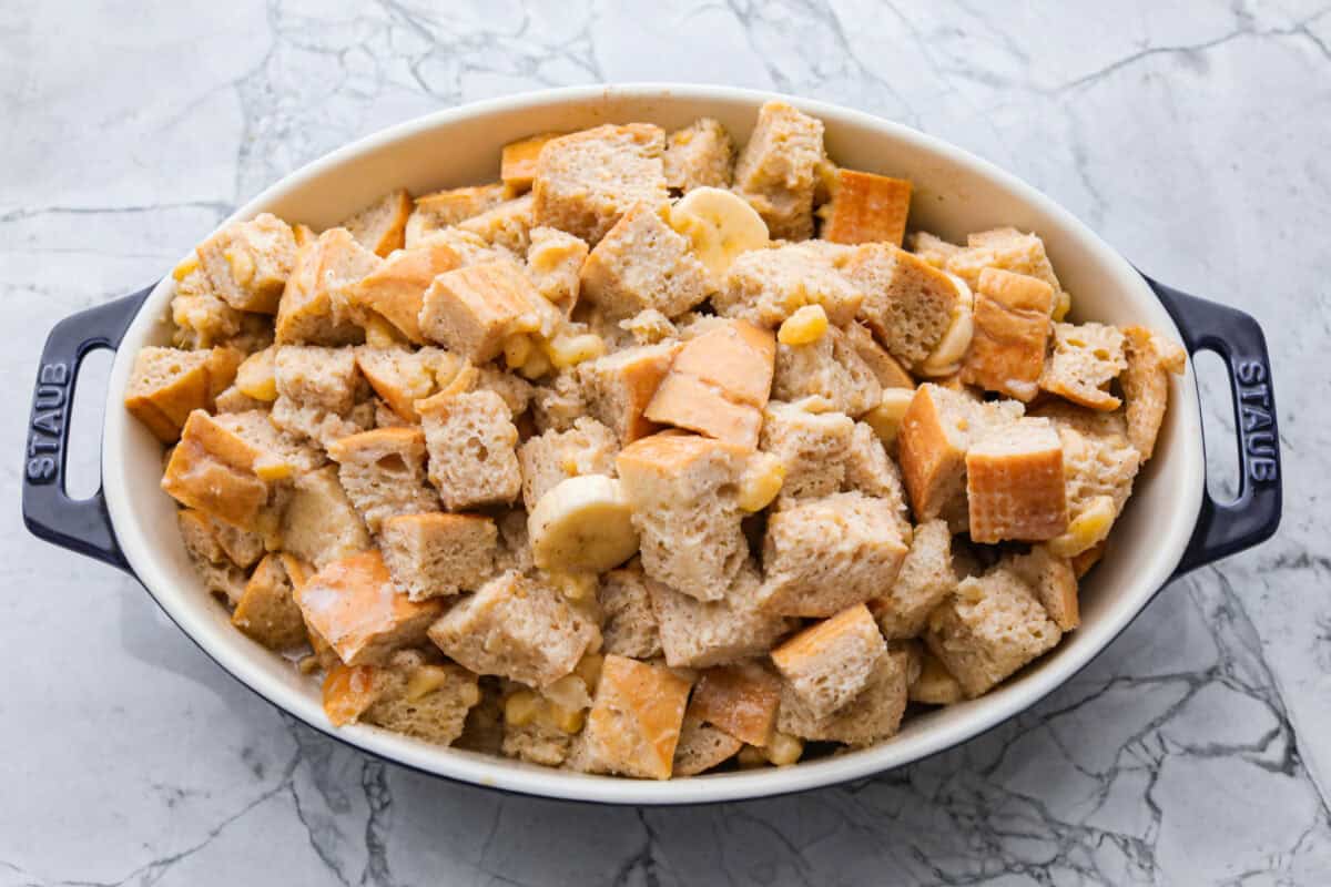 Bread pudding ingredients added to the baking dish ready to go in the oven. 