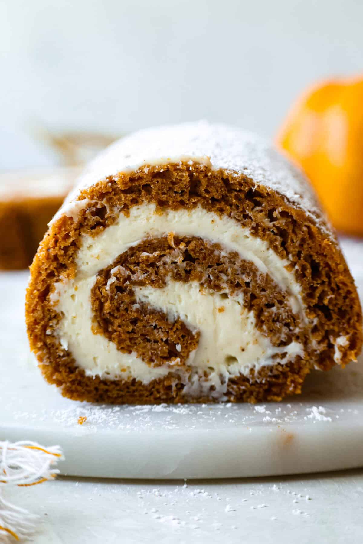 Side view of sliced pumpkin roll cake. 
