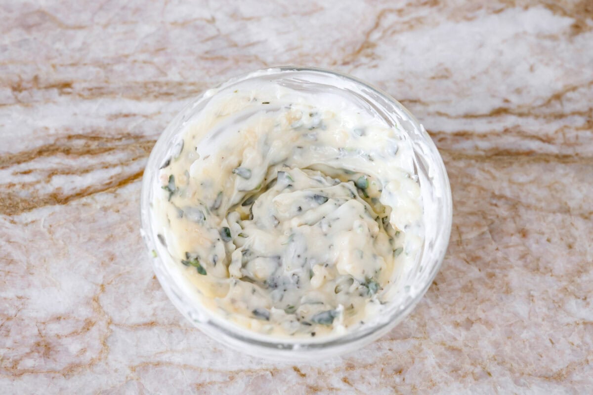 Garlic herb butter ingredients mixed together in a bowl.