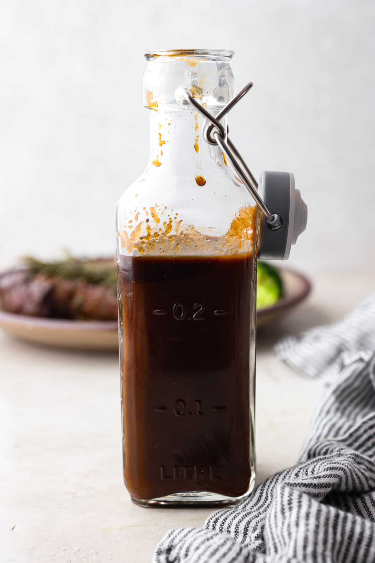 Side shot of homemade steak sauce in a bottle. 