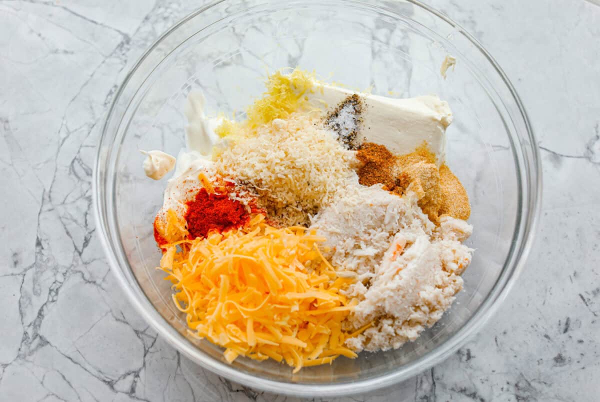 All of the ingredients added to a mixing bowl.