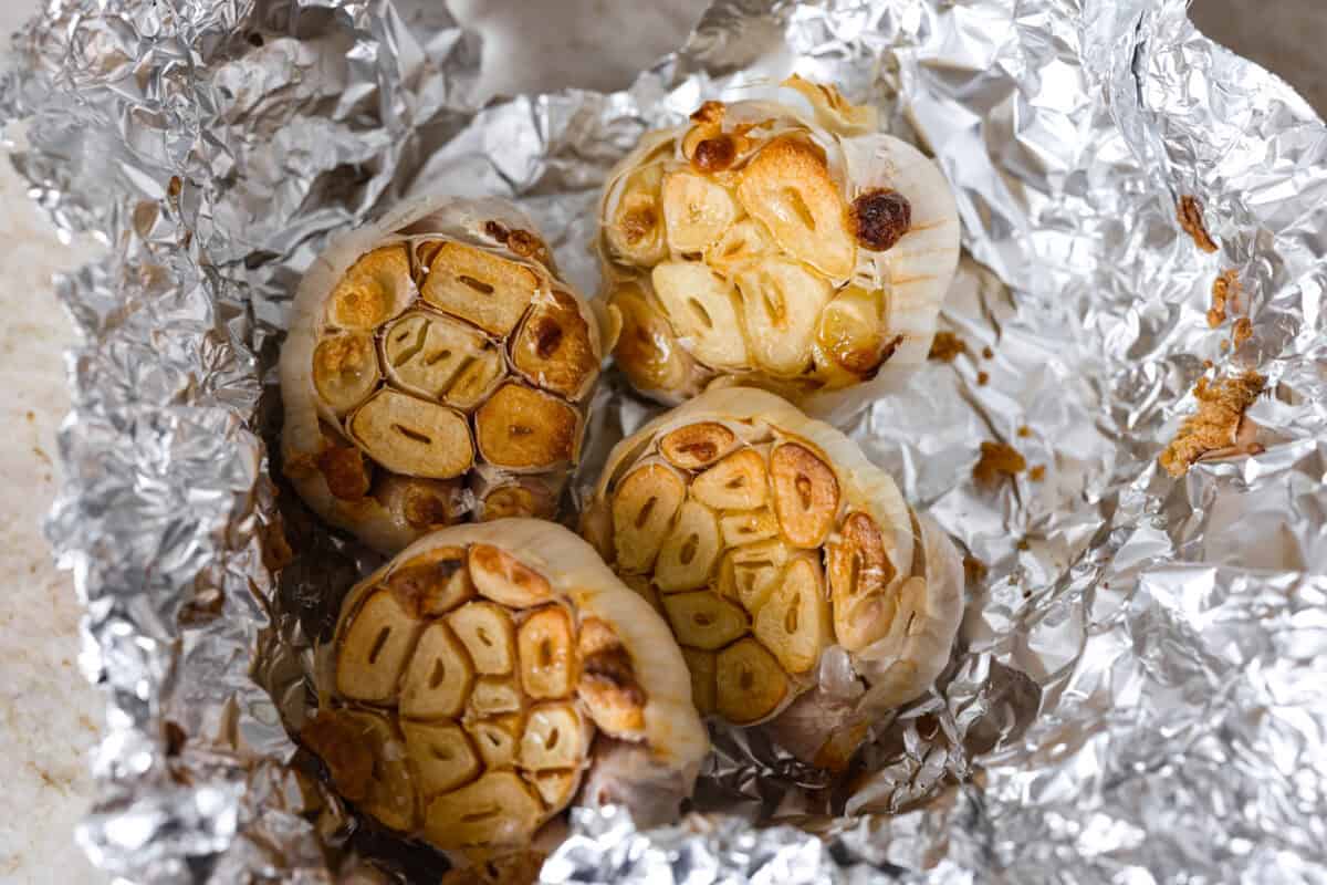 Roasted garlic heads in tin foil. 