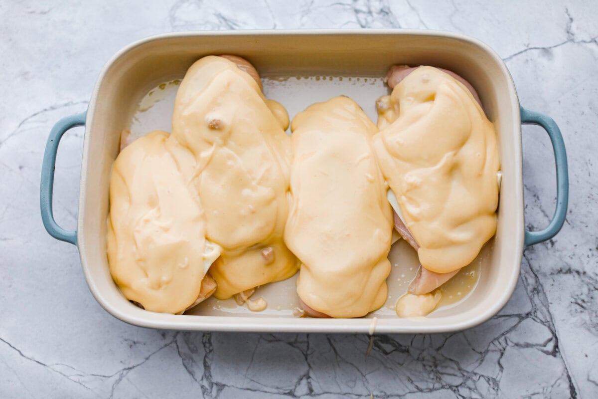 Soup mixture spread over the cheese on top of the chicken breasts. 