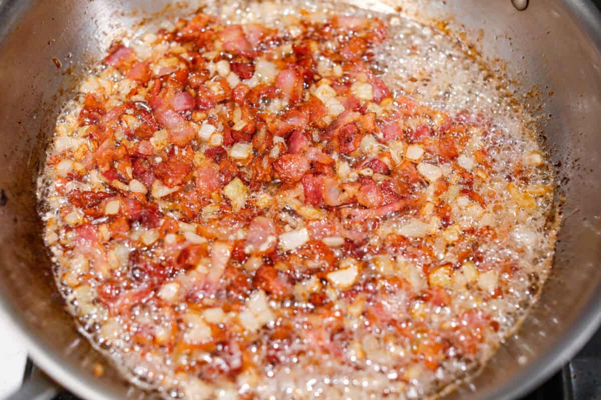 Overhead shot of the garlic cooking with the bacon and onions. 