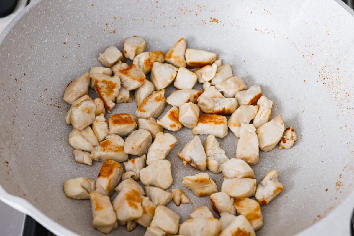 Chicken cooking in a skillet.