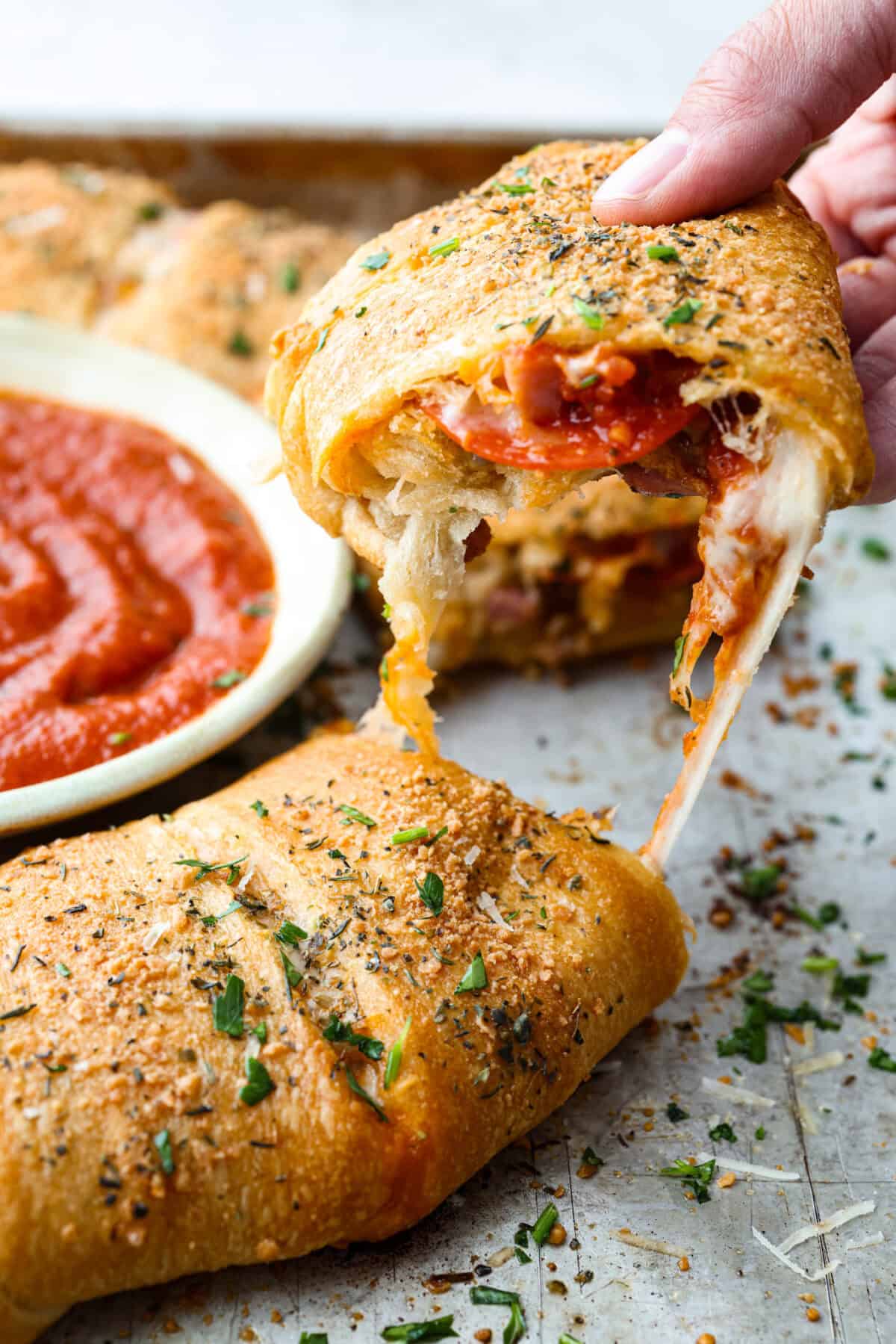 Someone pulling a slice of the pizza ring up.