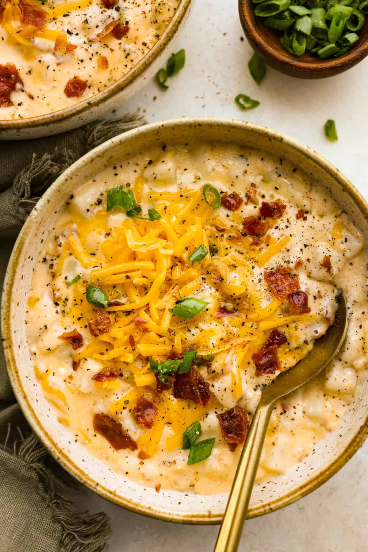 Overhead shot of plated crock pot crack potato soup in bowls. 