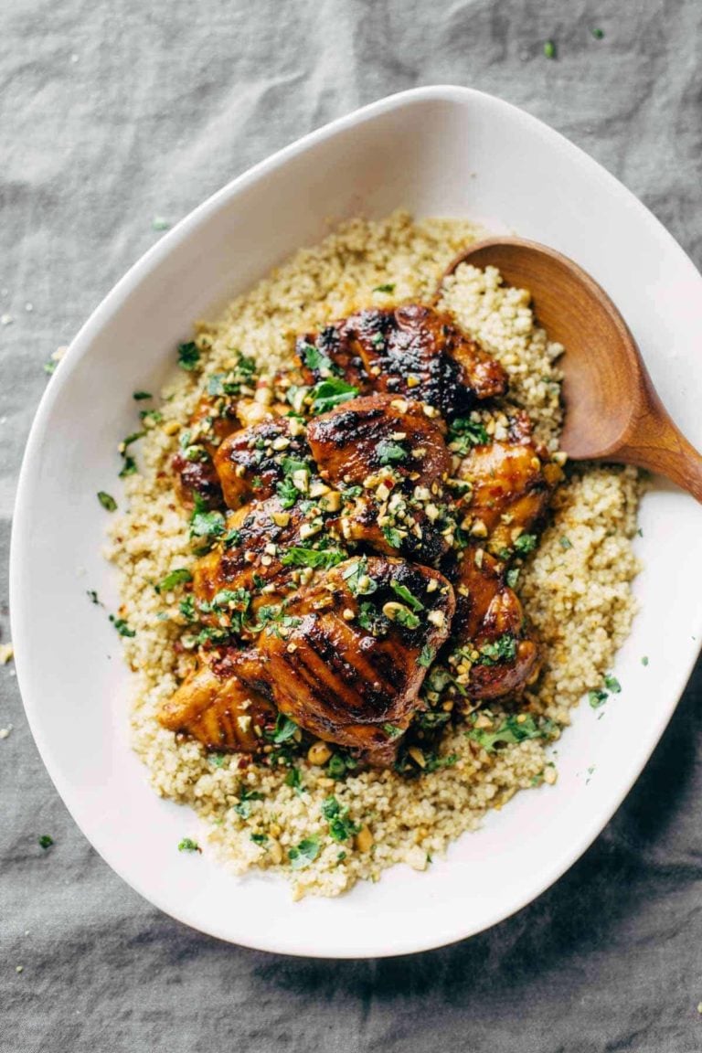 Thai chicken on a platter of quinoa.