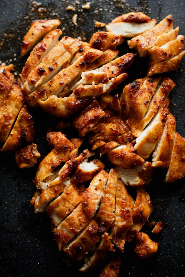 Air fryer chicken on a cutting board.