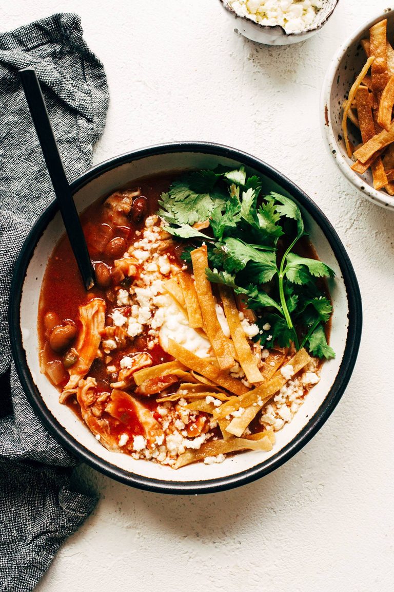 Chicken tortilla soup in a bowl with cilantro.