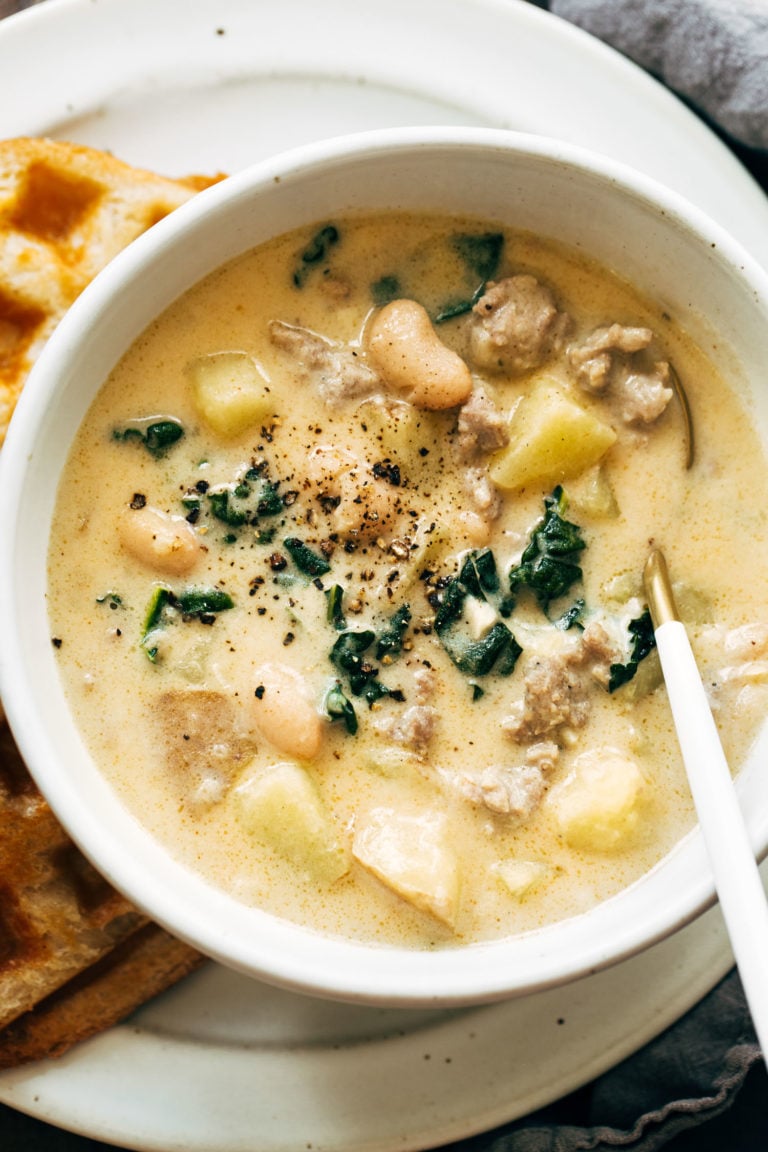 Sausage, kale, and white bean soup in a bowl.