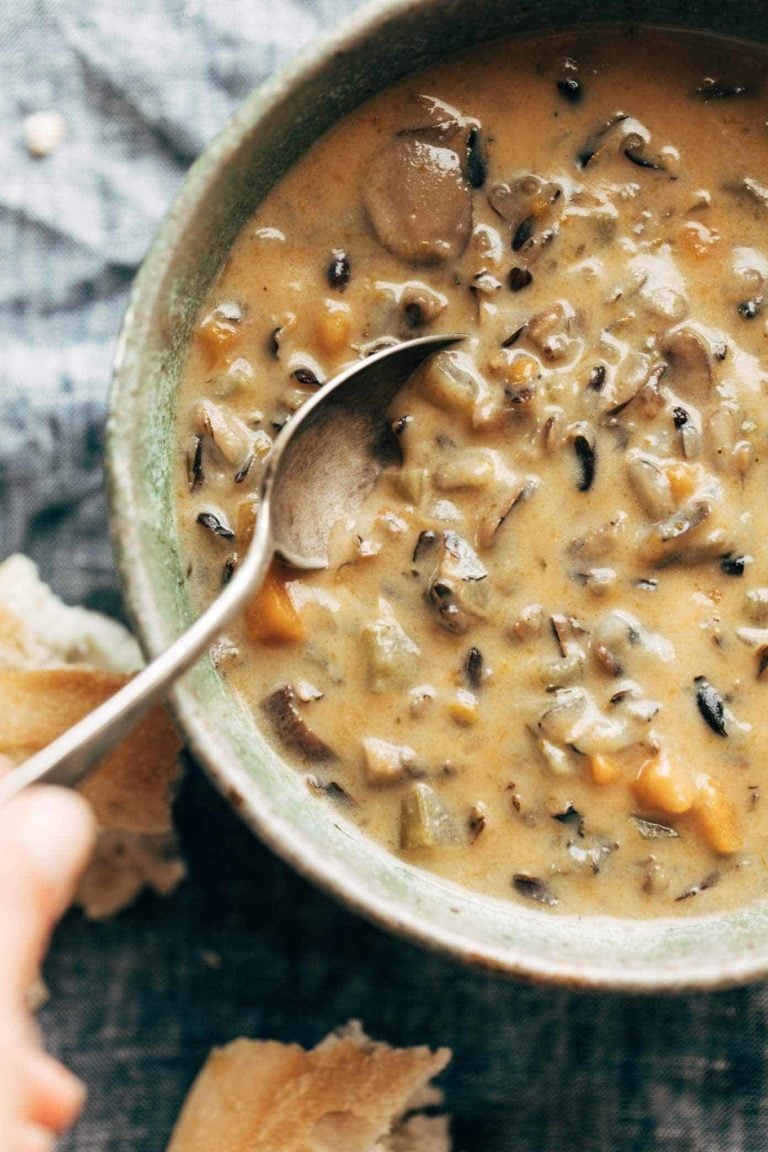 Wild rice soup in a bowl with a spoon.