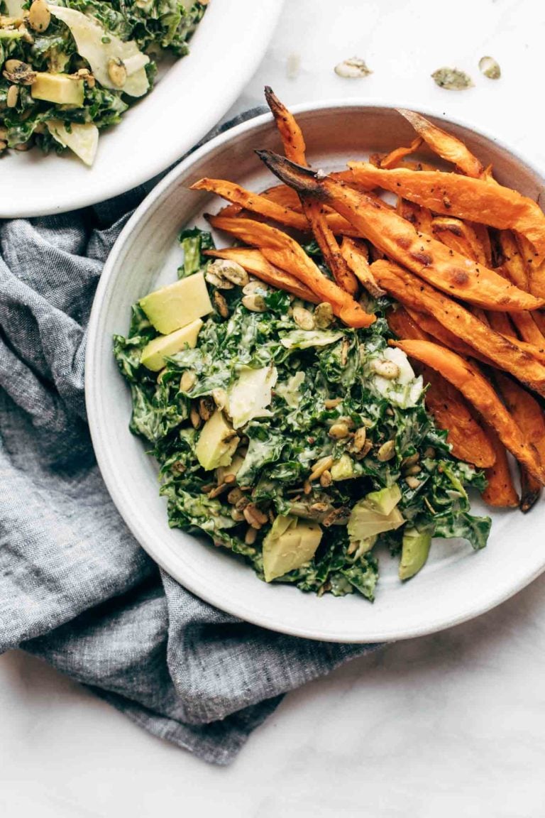 Avocado kale caesar salad with sweet potato fries.