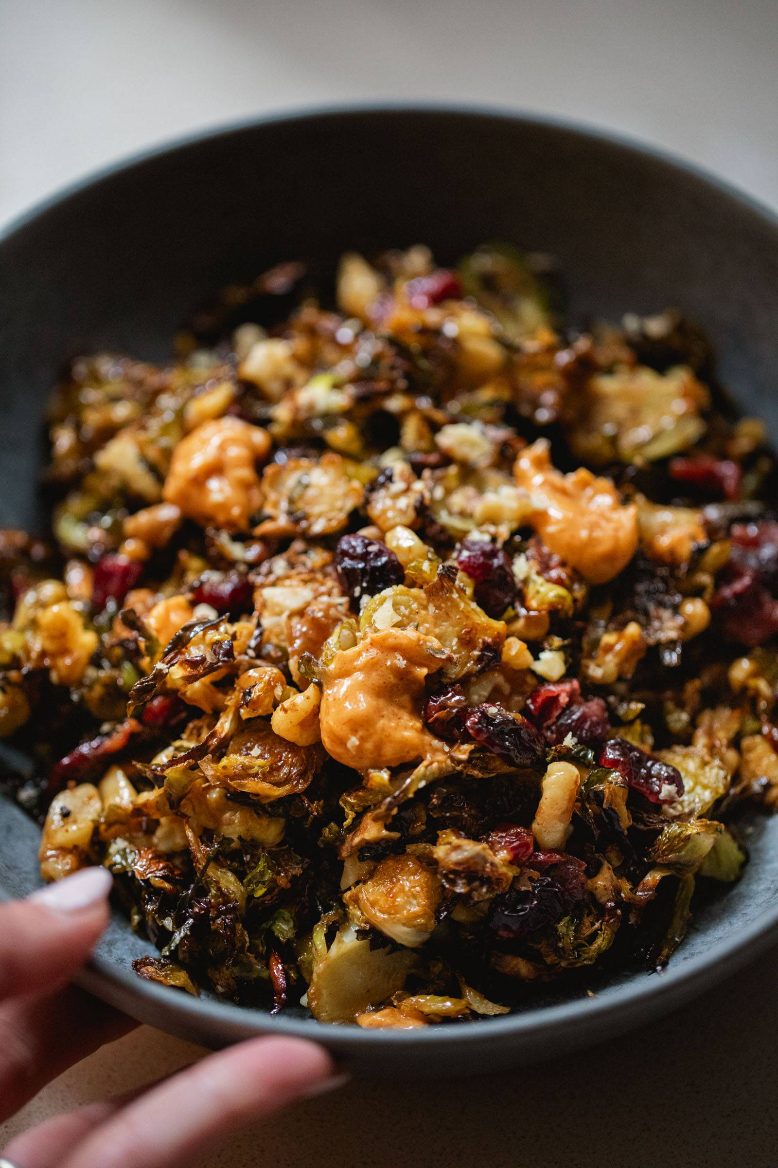 Brussels sprouts in a bowl with gochujang butter on top.