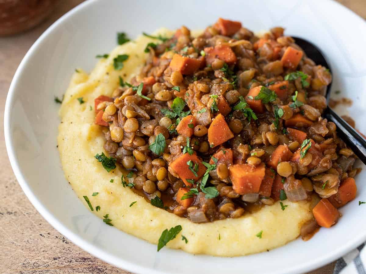 side view of spiced lentils on a bed of polenta