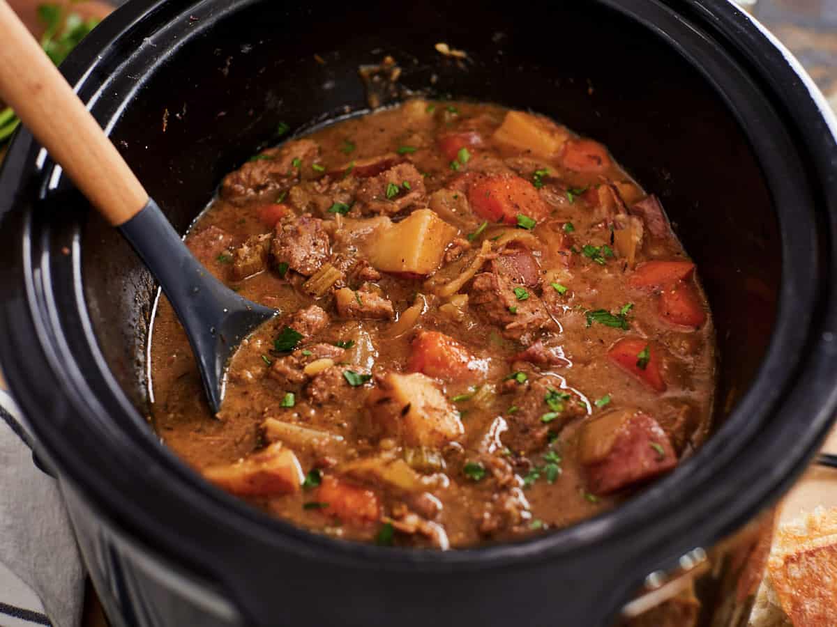 Side view of beef stew in the slow cooker.