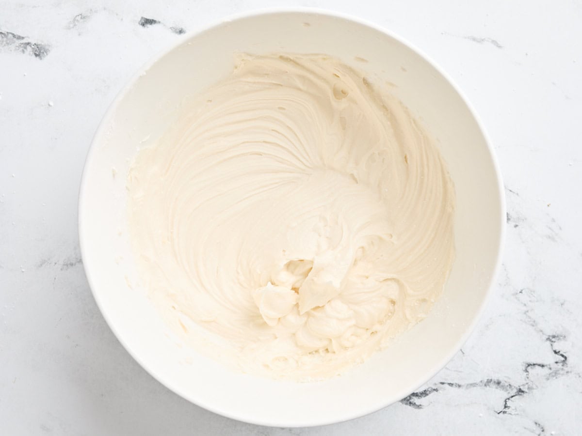 Vanilla frosting in a mixing bowl.